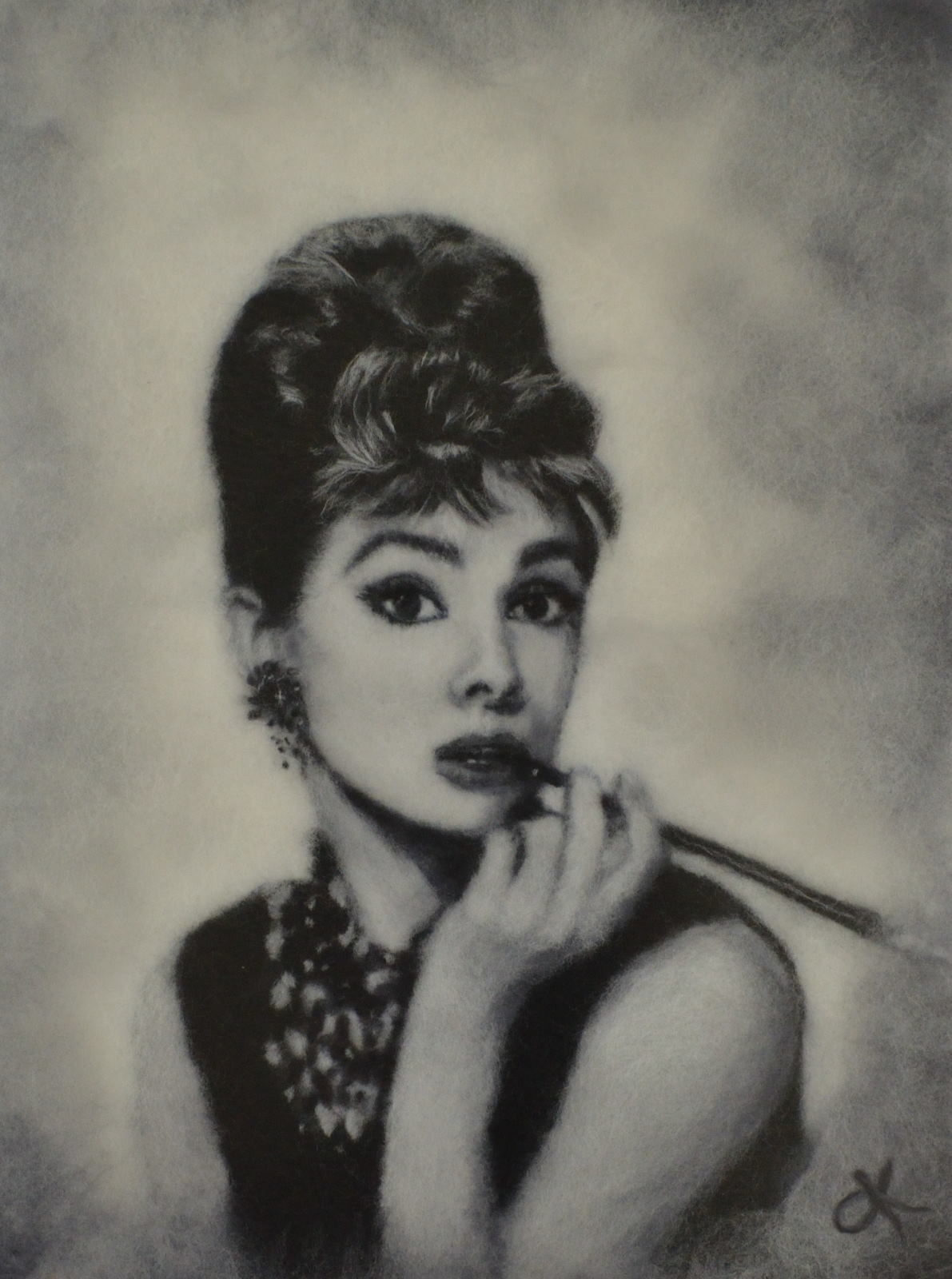 Portrait of Audrey Hepburn with a cigarette holder made of merino wool. Wool Art Gallery