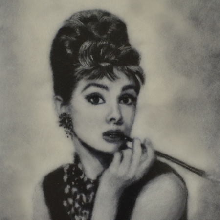 Portrait of Audrey Hepburn with a cigarette holder made of merino wool. Wool Art Gallery