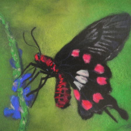 Wool picture with a butterfly sitting on a twig. Wool Art Gallery